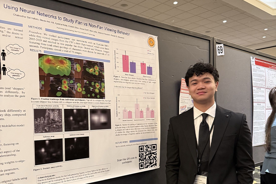 A student infront of their poster