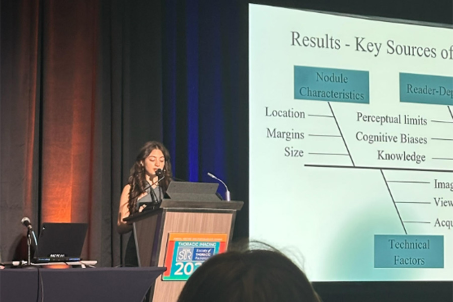Talia Lilikakis presenting on stage