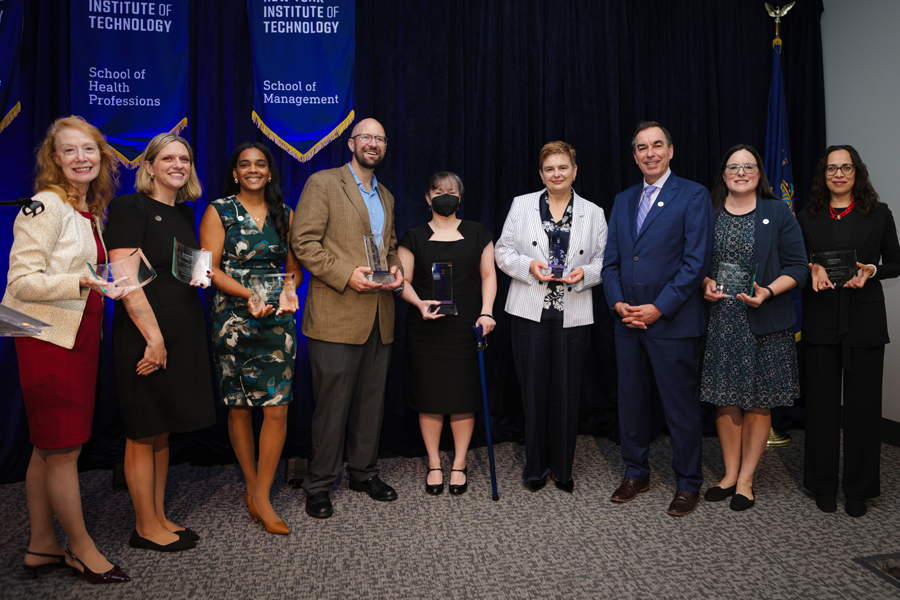 Group of faculty holding awards