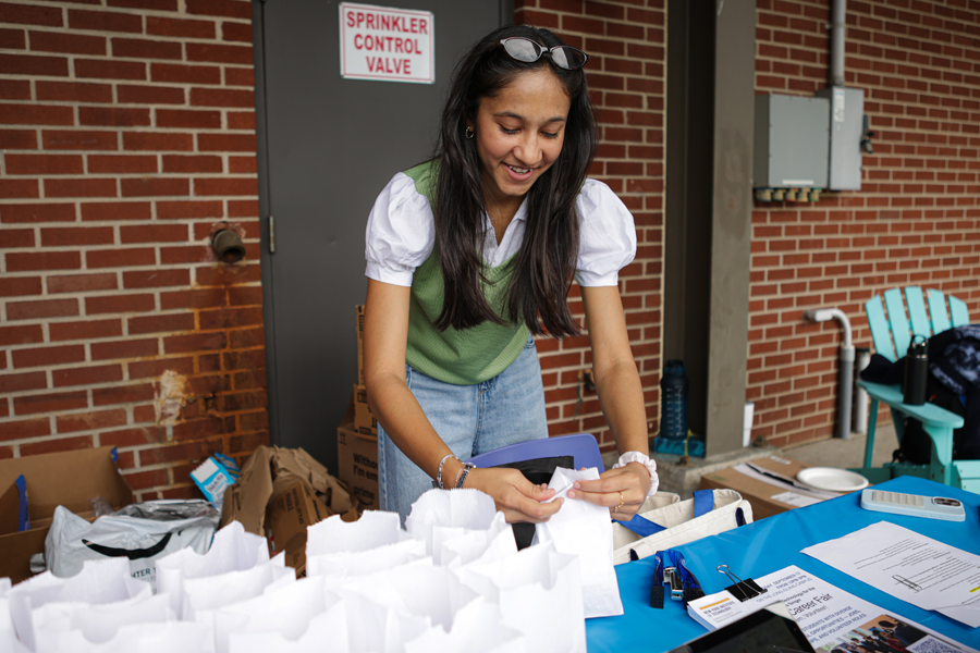 Young woman folding bags