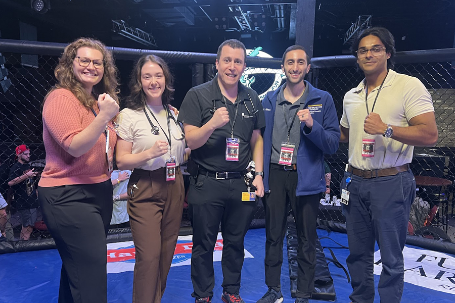 Students and their professor standing in a boxing ring