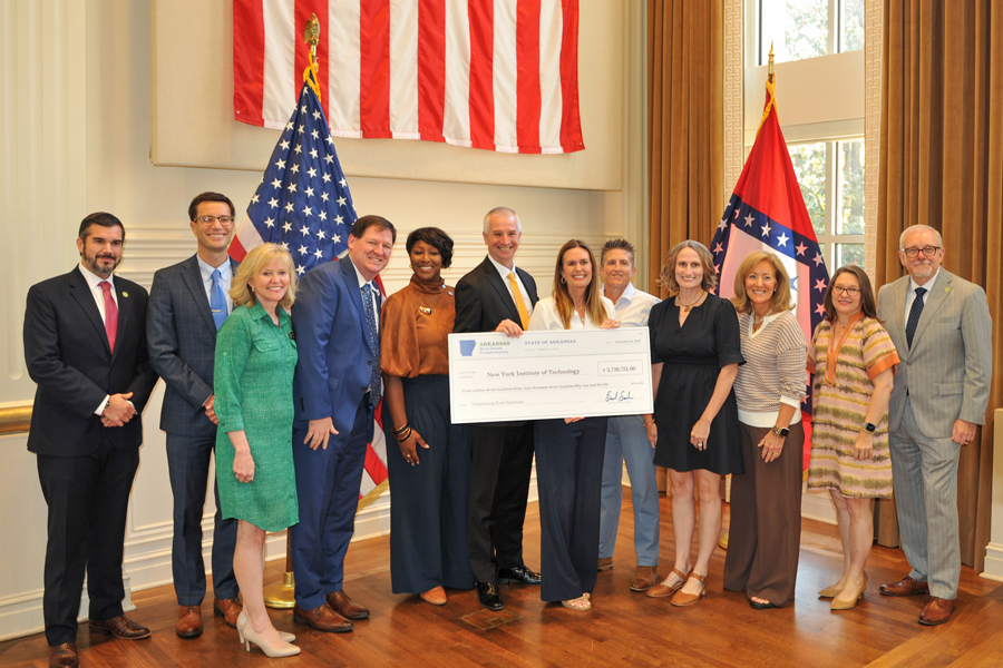 Group of people holding large check