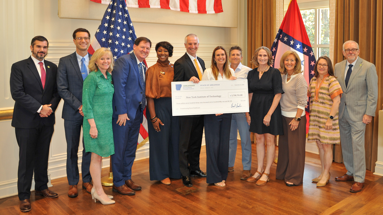 Group of people holding large check