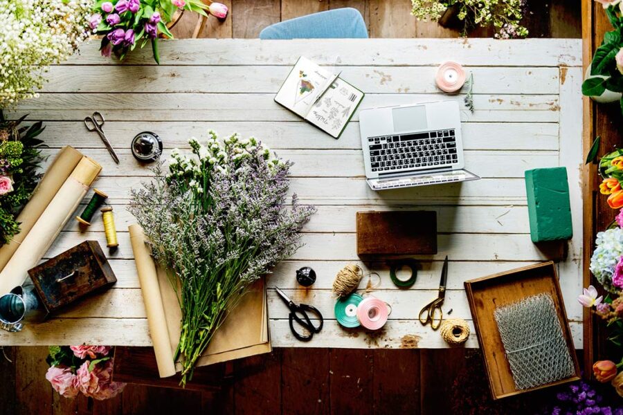 A view of a table from above, covered with arts, craft, and collage materials.