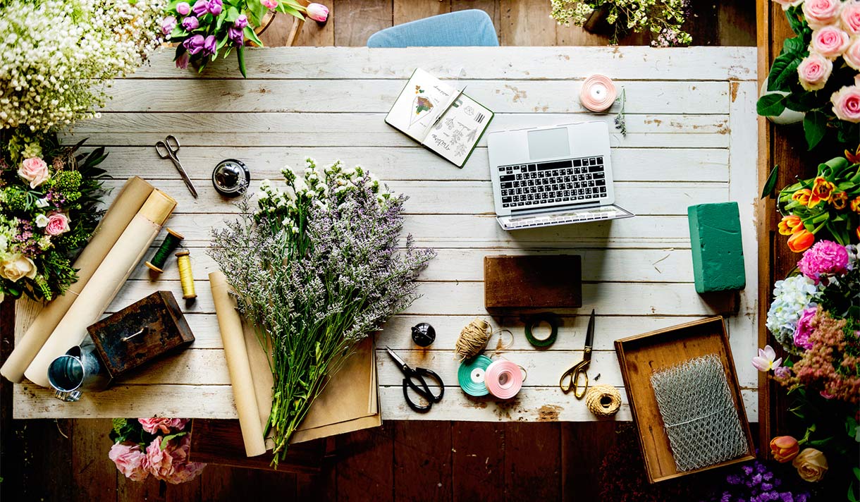 A view of a table from above, covered with arts, craft, and collage materials.