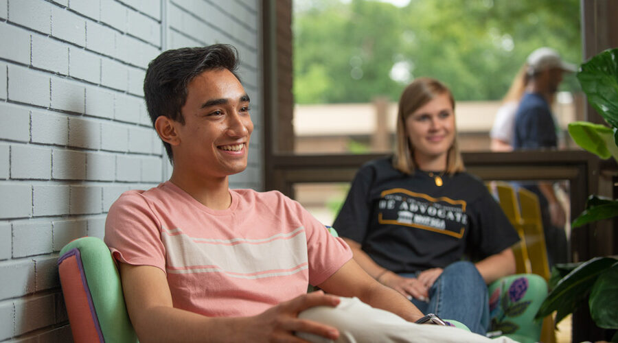 Two students lounge inside a building on New York Tech's Long Island Campus.