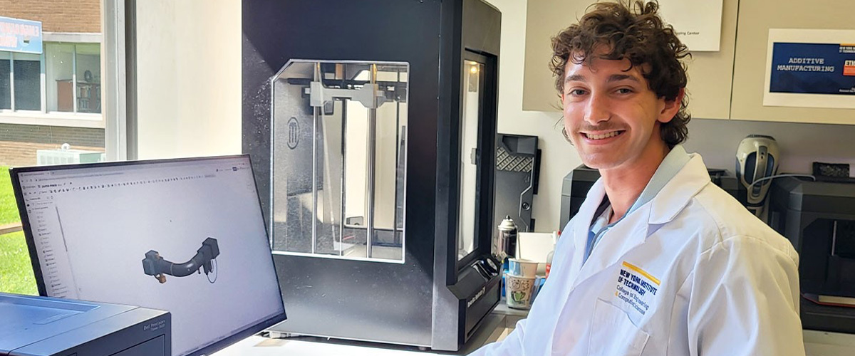 Brandon Castellano at a computer next to a 3-D printer