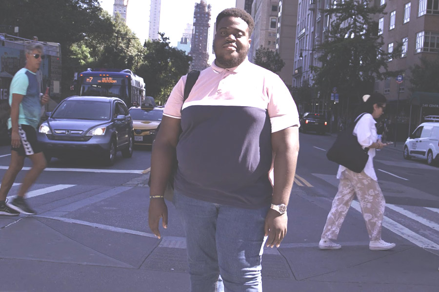 Student Michael Aryeetey smiling on an New York City street